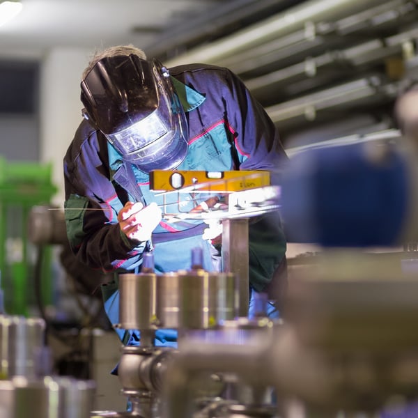 Industrial Worker Welding in Metal Factory